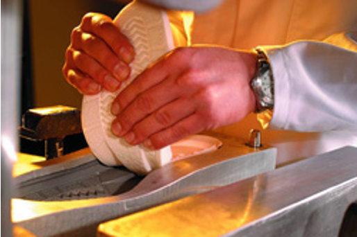 A PU midsole is peeled from a steel mold